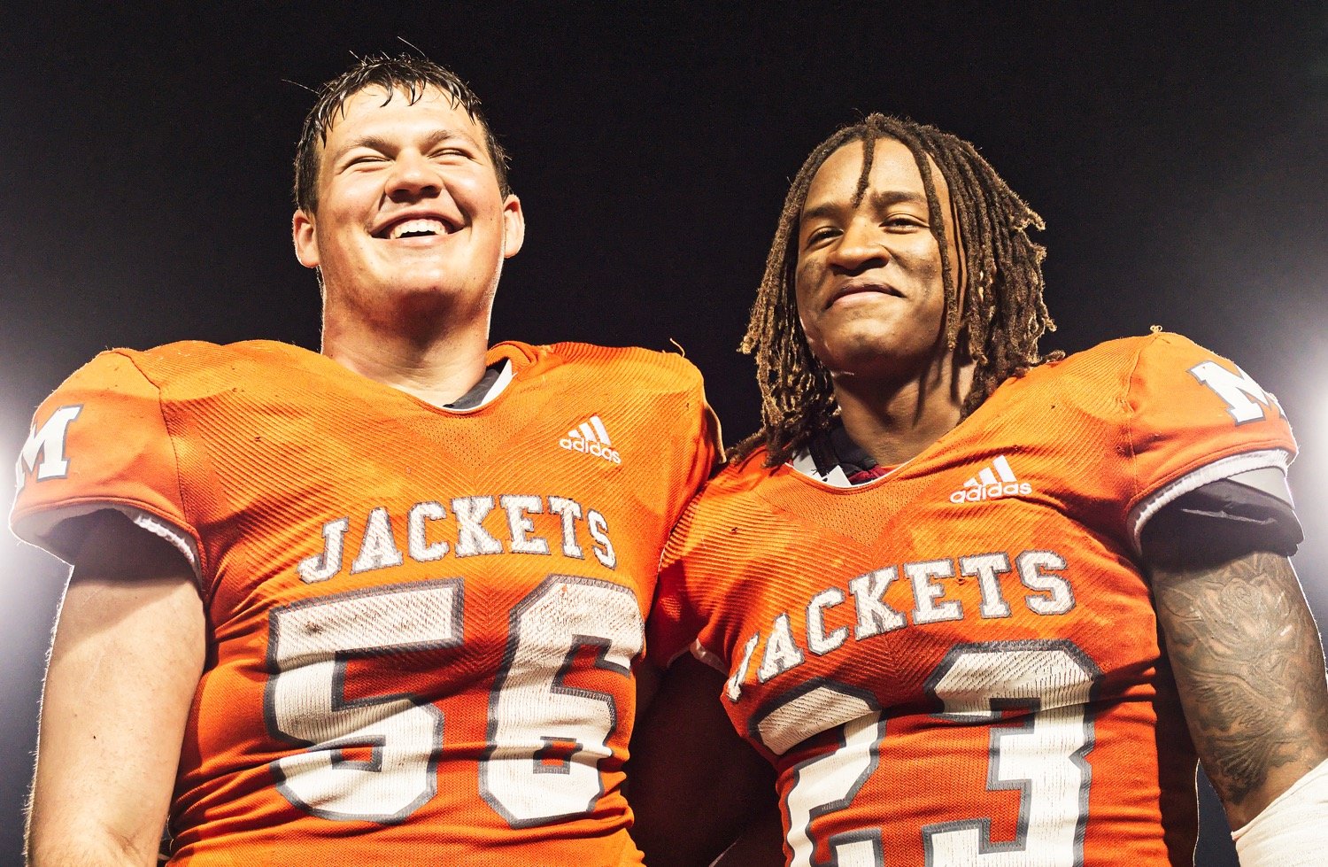 Jackson Anderson, left, and Trevion Sneed celebrating the Yellowjackets' area championship over Dallas Madison. Anderson was selected as offensive lineman of the year and Sneed was named district MVP.  [print available]